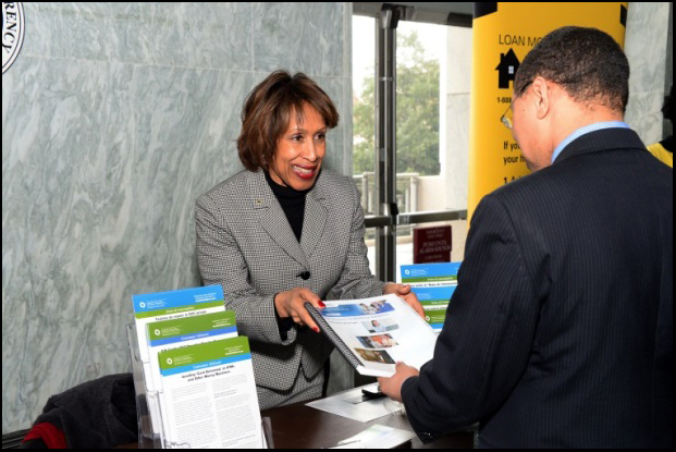 Community Development Specialist Denise Murray promotes the OCC's Helpwithmybank.gov Question and Answer booklet as a resource for financial concerns.